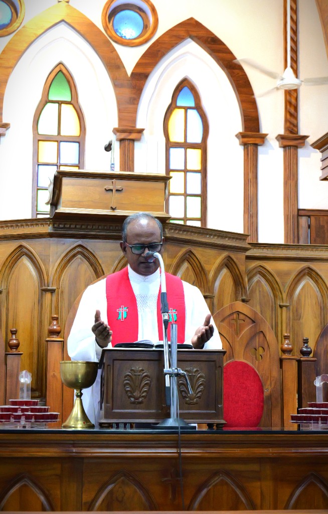 Presbyter leading prayer from the pulpit